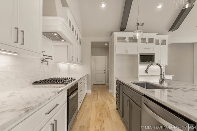 kitchen with white cabinetry, appliances with stainless steel finishes, hanging light fixtures, and sink