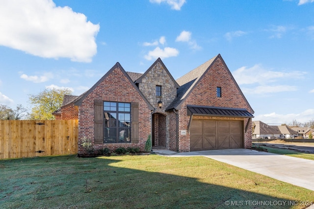 view of front of house featuring a garage and a front lawn