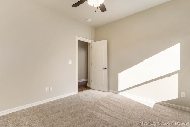 spare room featuring carpet flooring and ceiling fan