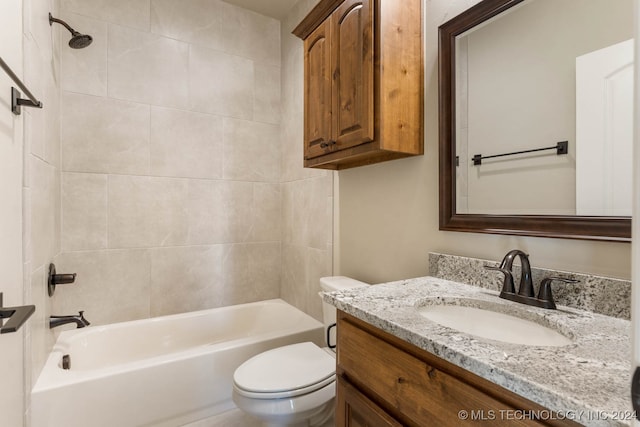 full bathroom featuring tiled shower / bath combo, toilet, and vanity