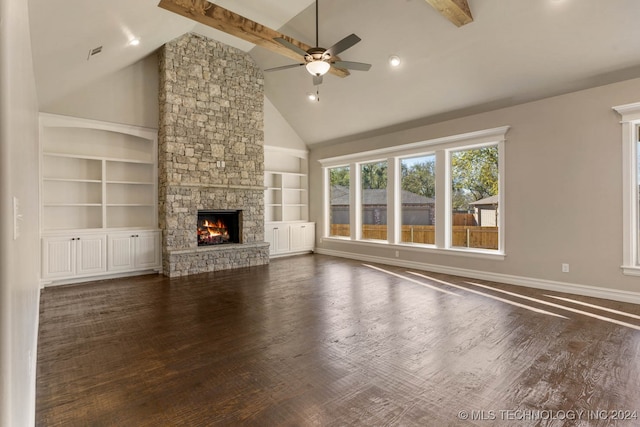 unfurnished living room featuring a fireplace, dark hardwood / wood-style flooring, high vaulted ceiling, and beamed ceiling