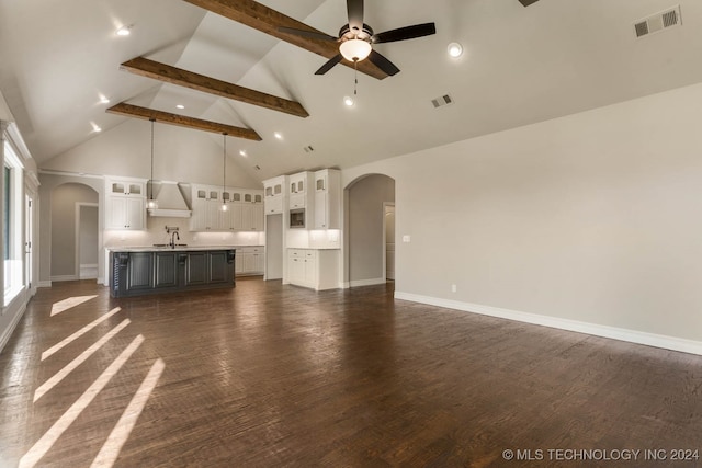 unfurnished living room with beam ceiling, ceiling fan, sink, high vaulted ceiling, and dark hardwood / wood-style floors