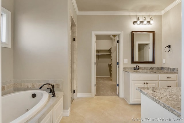 bathroom with tile patterned floors, vanity, a bath, and crown molding