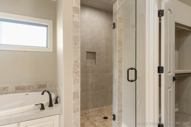 bathroom with shower with separate bathtub