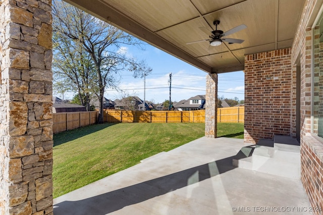 view of yard featuring ceiling fan and a patio