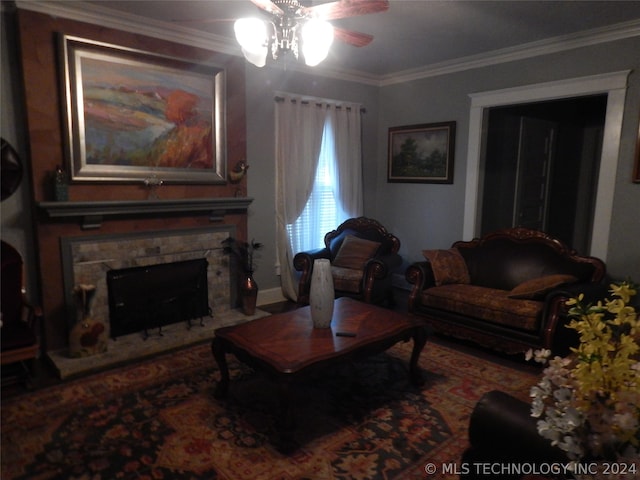 living room with ornamental molding, ceiling fan, and a fireplace