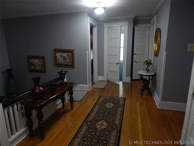 foyer entrance featuring ornamental molding and wood-type flooring