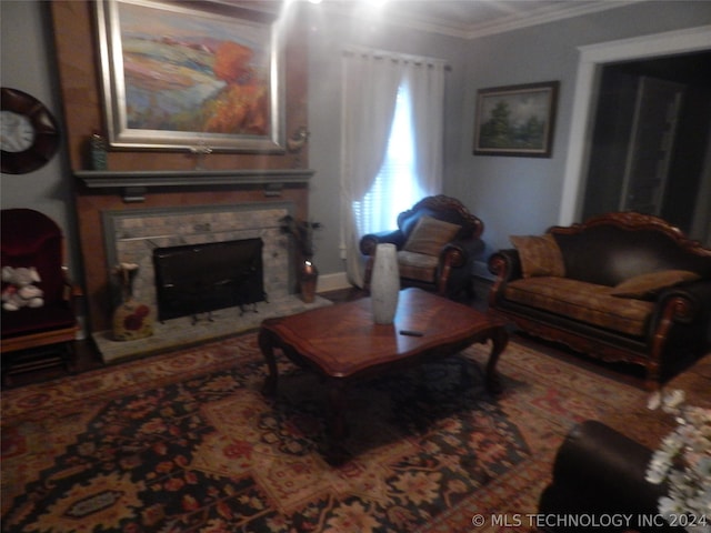 living room with ornamental molding and a fireplace