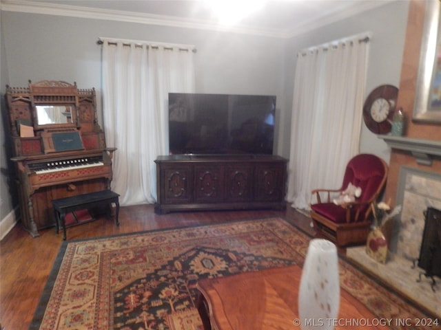 living room featuring ornamental molding and dark wood-type flooring