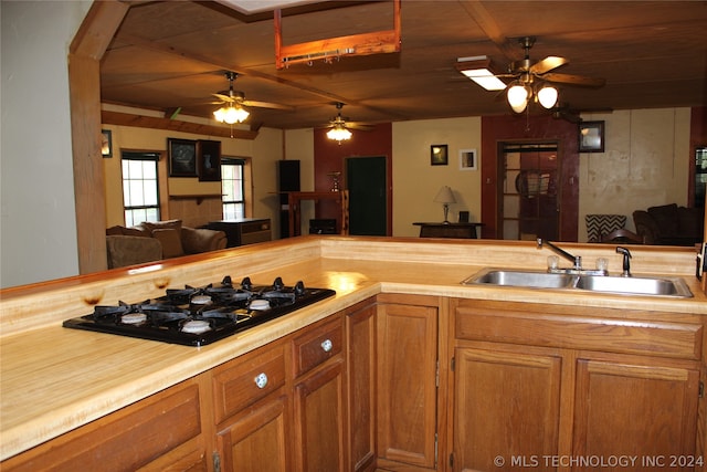 kitchen featuring black gas cooktop, wooden ceiling, ceiling fan, and sink