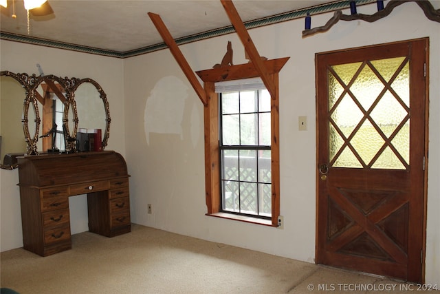 carpeted entrance foyer with ceiling fan