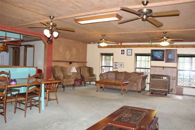 carpeted living room featuring a healthy amount of sunlight, ceiling fan, and wooden ceiling