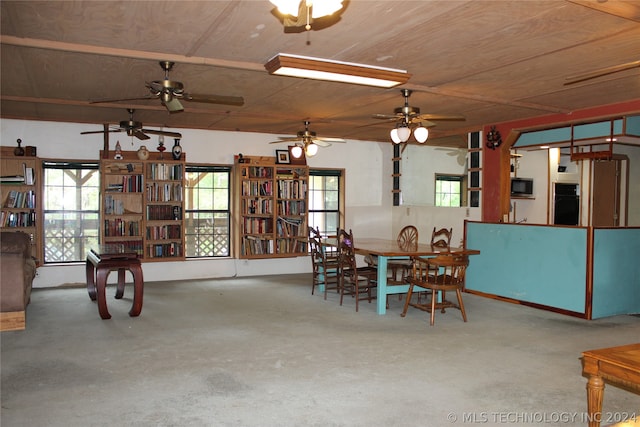 carpeted dining space with ceiling fan and wooden ceiling