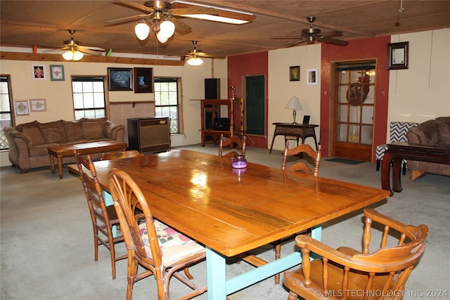 dining area featuring light colored carpet, wooden ceiling, and ceiling fan