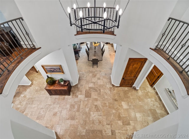 foyer with a towering ceiling and a chandelier