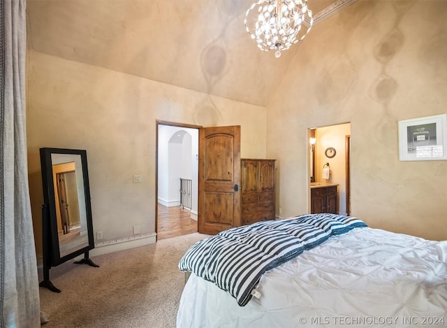 carpeted bedroom with high vaulted ceiling, arched walkways, ensuite bath, and an inviting chandelier