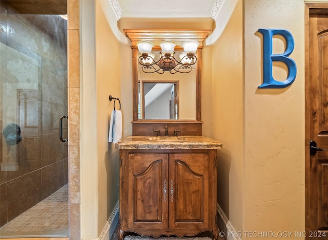 bathroom with vanity, crown molding, and a shower with door