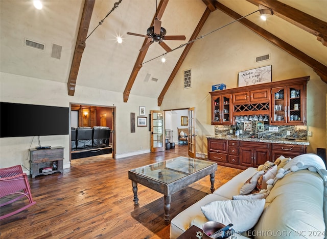 living room with bar, high vaulted ceiling, hardwood / wood-style flooring, beamed ceiling, and ceiling fan