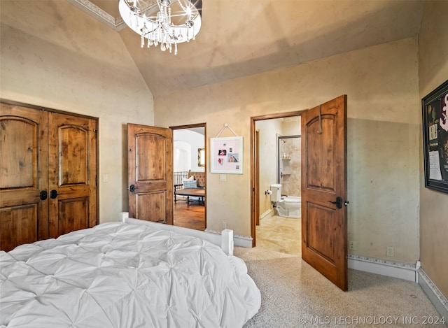 bedroom featuring high vaulted ceiling, a chandelier, and ensuite bathroom