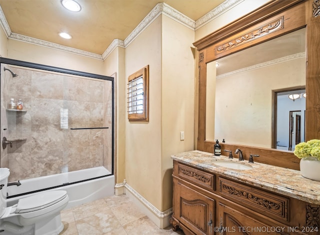 full bathroom featuring vanity, bath / shower combo with glass door, and toilet