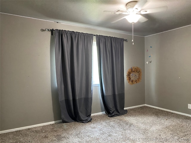 spare room with carpet and ceiling fan