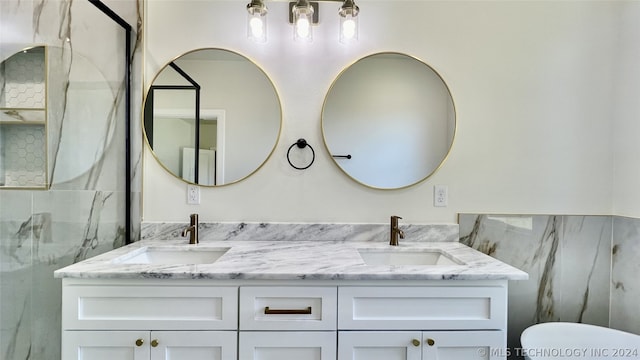 bathroom with toilet and double sink vanity