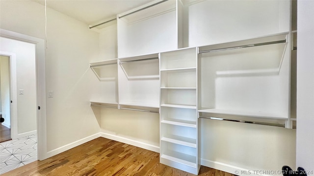 spacious closet with tile floors