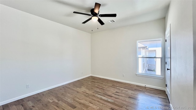 spare room with hardwood / wood-style floors and ceiling fan