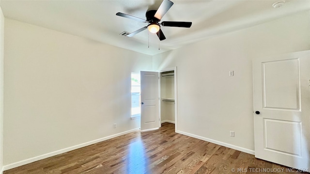 unfurnished bedroom featuring wood-type flooring, a closet, and ceiling fan