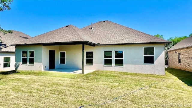 back of house featuring a patio and a yard