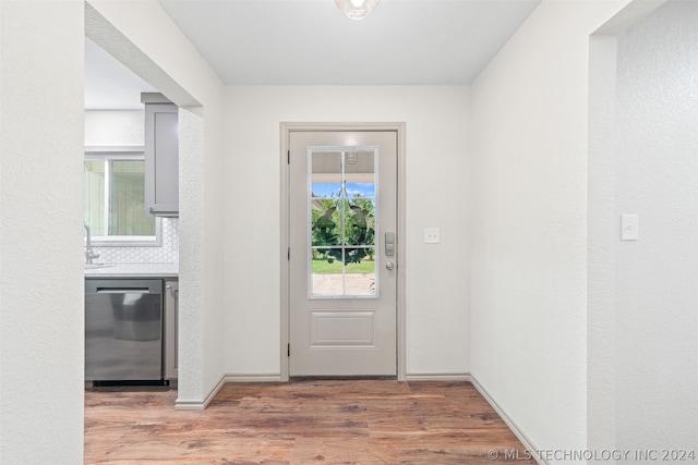 doorway with hardwood / wood-style flooring