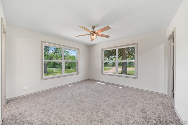 unfurnished room featuring ceiling fan and carpet floors