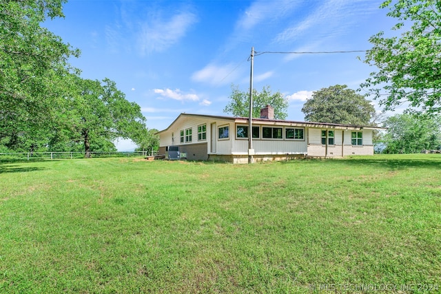 rear view of house with a lawn