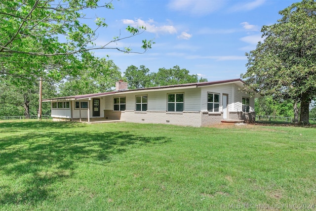 rear view of house with a lawn