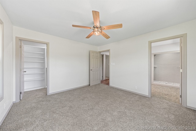 unfurnished bedroom featuring carpet flooring, a closet, and ceiling fan