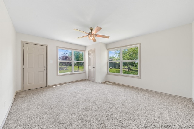 carpeted empty room featuring ceiling fan