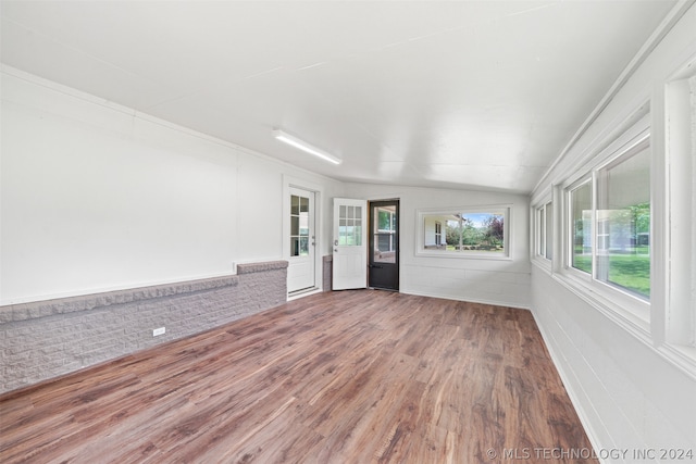 unfurnished sunroom featuring lofted ceiling