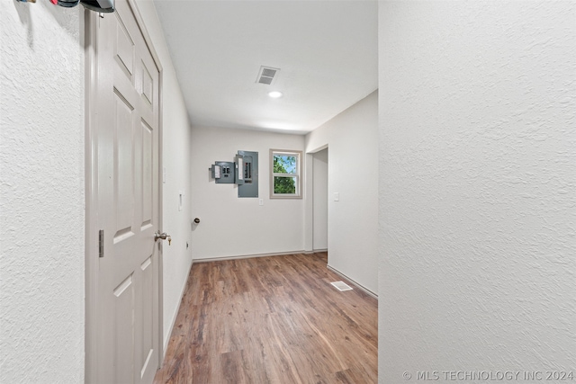 hallway with hardwood / wood-style floors