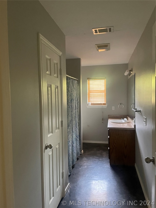 bathroom featuring concrete floors and vanity