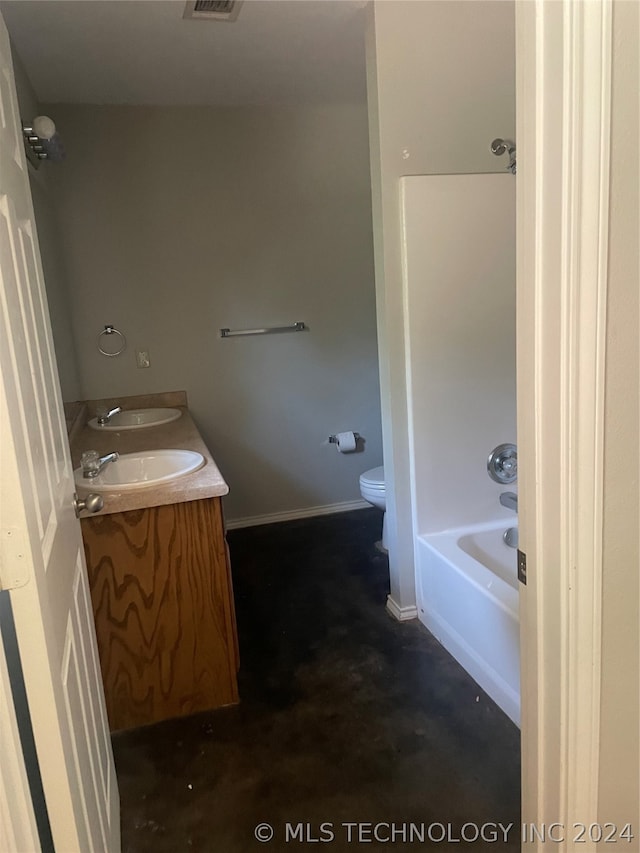 full bathroom featuring dual bowl vanity, concrete floors, toilet, and  shower combination