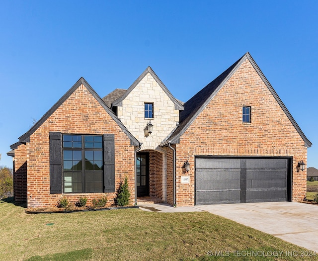 view of front of house with a garage and a front yard