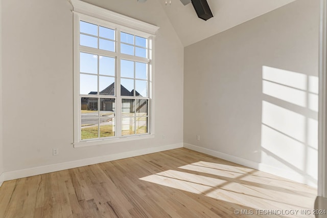 empty room featuring light hardwood / wood-style flooring and vaulted ceiling