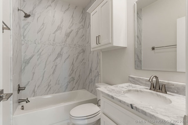 full bathroom with toilet, vanity, and tiled shower / bath