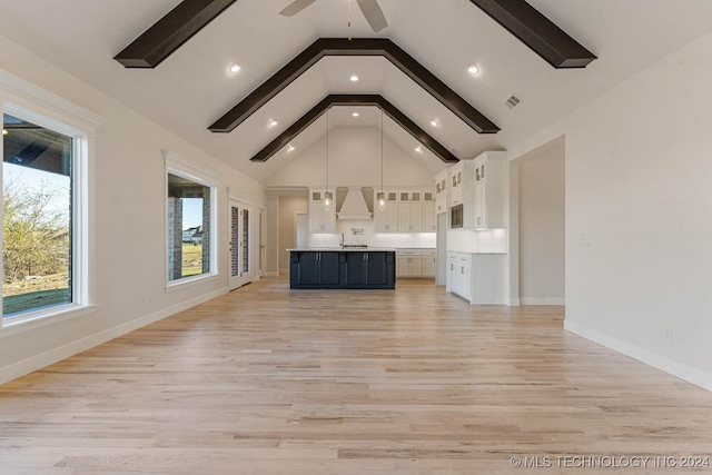 unfurnished living room with beam ceiling, light wood-type flooring, high vaulted ceiling, and ceiling fan