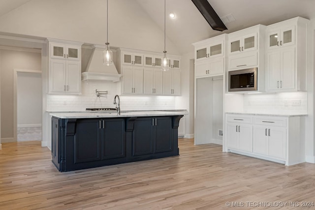 kitchen featuring white cabinets and stainless steel microwave