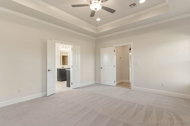 unfurnished bedroom featuring connected bathroom, light carpet, crown molding, and ceiling fan