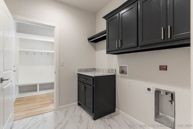 washroom with cabinets, washer hookup, light wood-type flooring, and electric dryer hookup