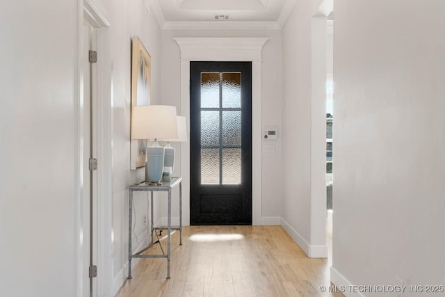 entrance foyer featuring ornamental molding and light hardwood / wood-style flooring