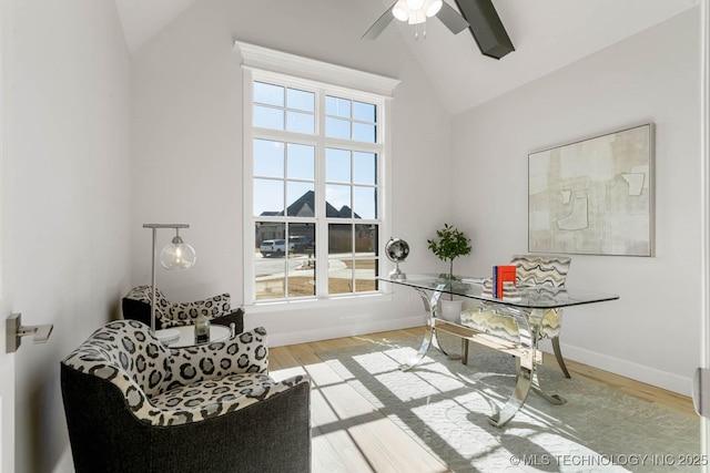 home office featuring vaulted ceiling, ceiling fan, and light wood-type flooring