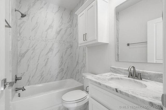 full bathroom featuring tiled shower / bath combo, vanity, and toilet